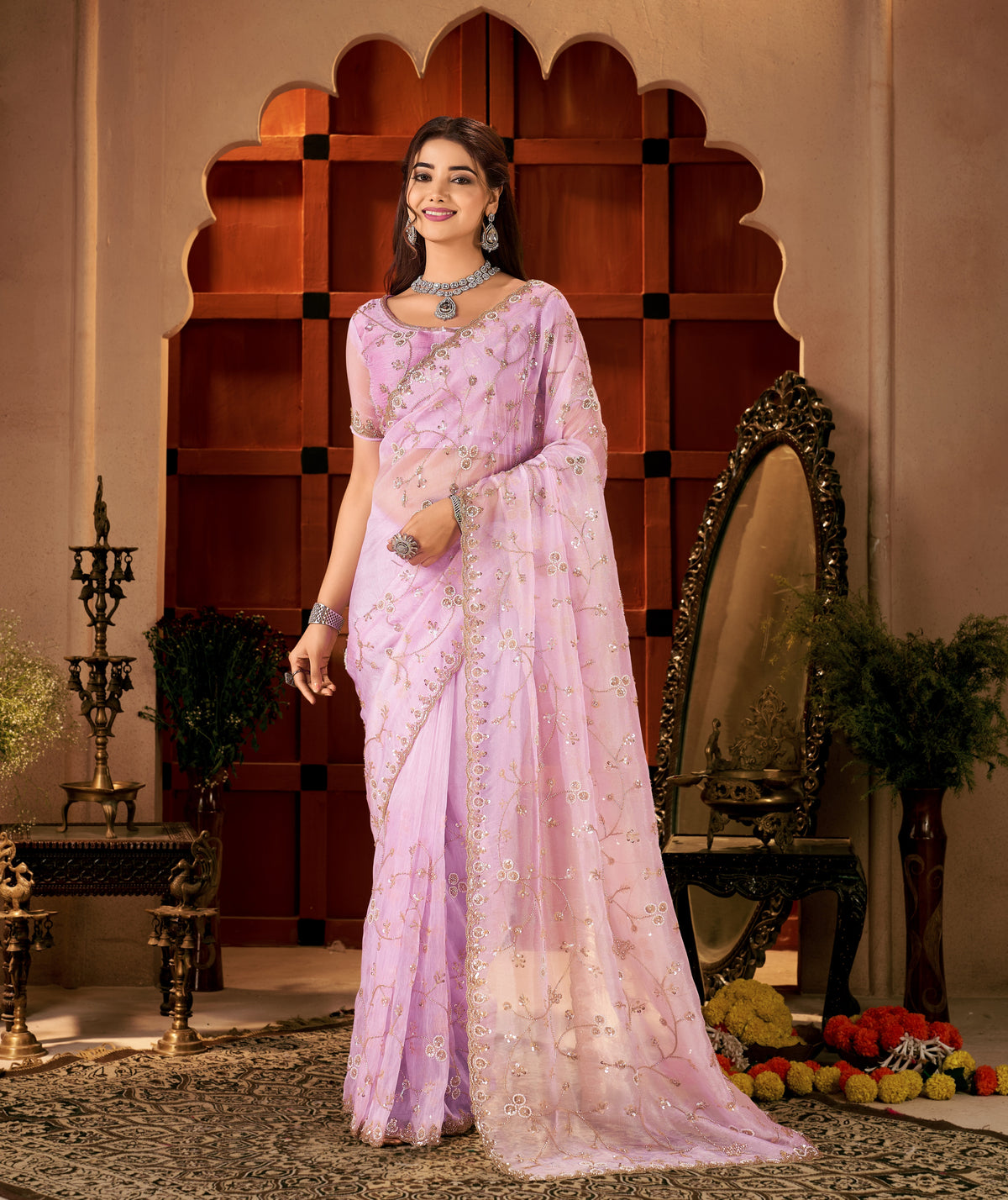 Model wearing Chhoga Lavender Pink Tissue Silk Saree with intricate hand work.