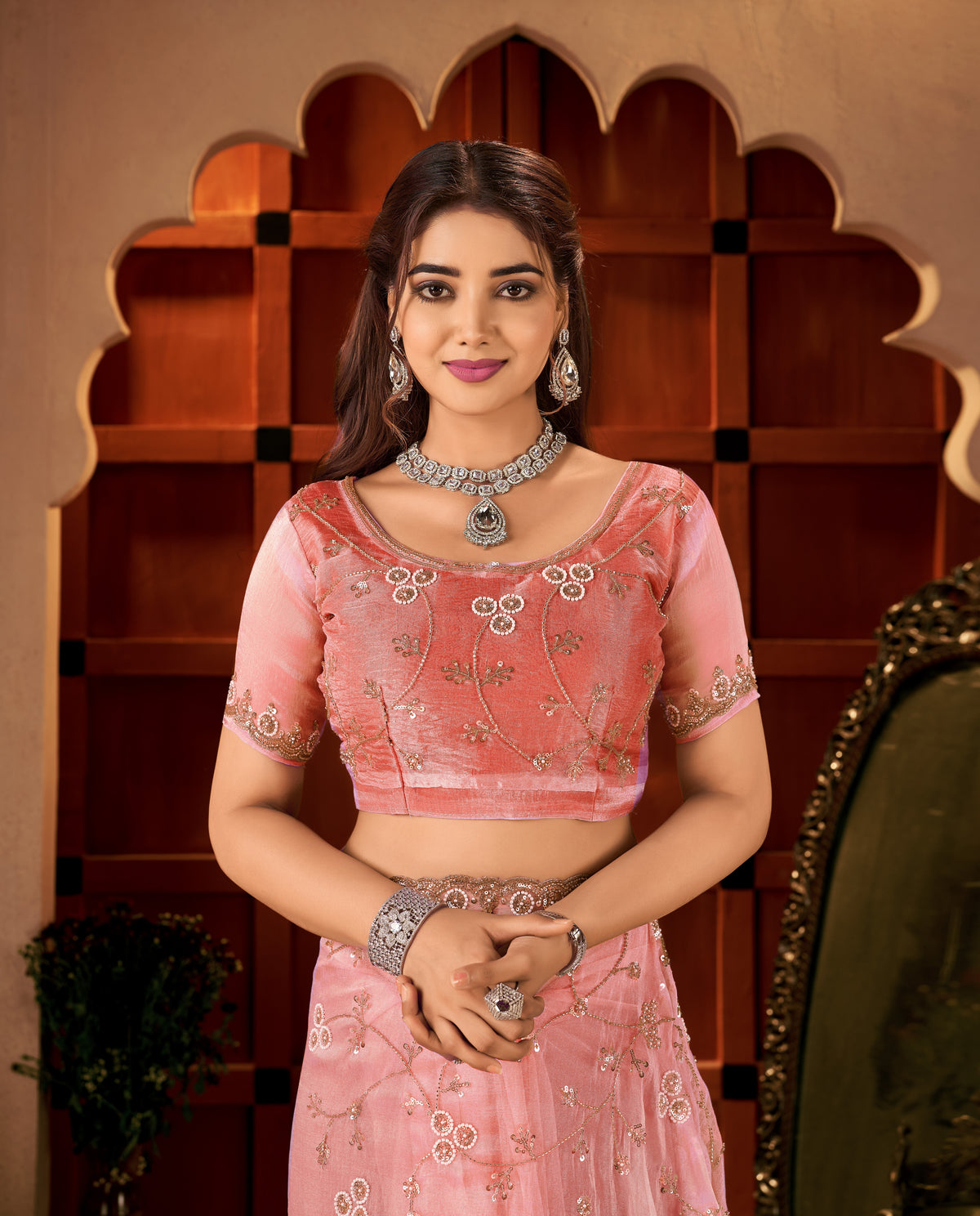 close-up of the blouse back design featuring elegant hand work on the chhoga rose pink tissue silk saree.