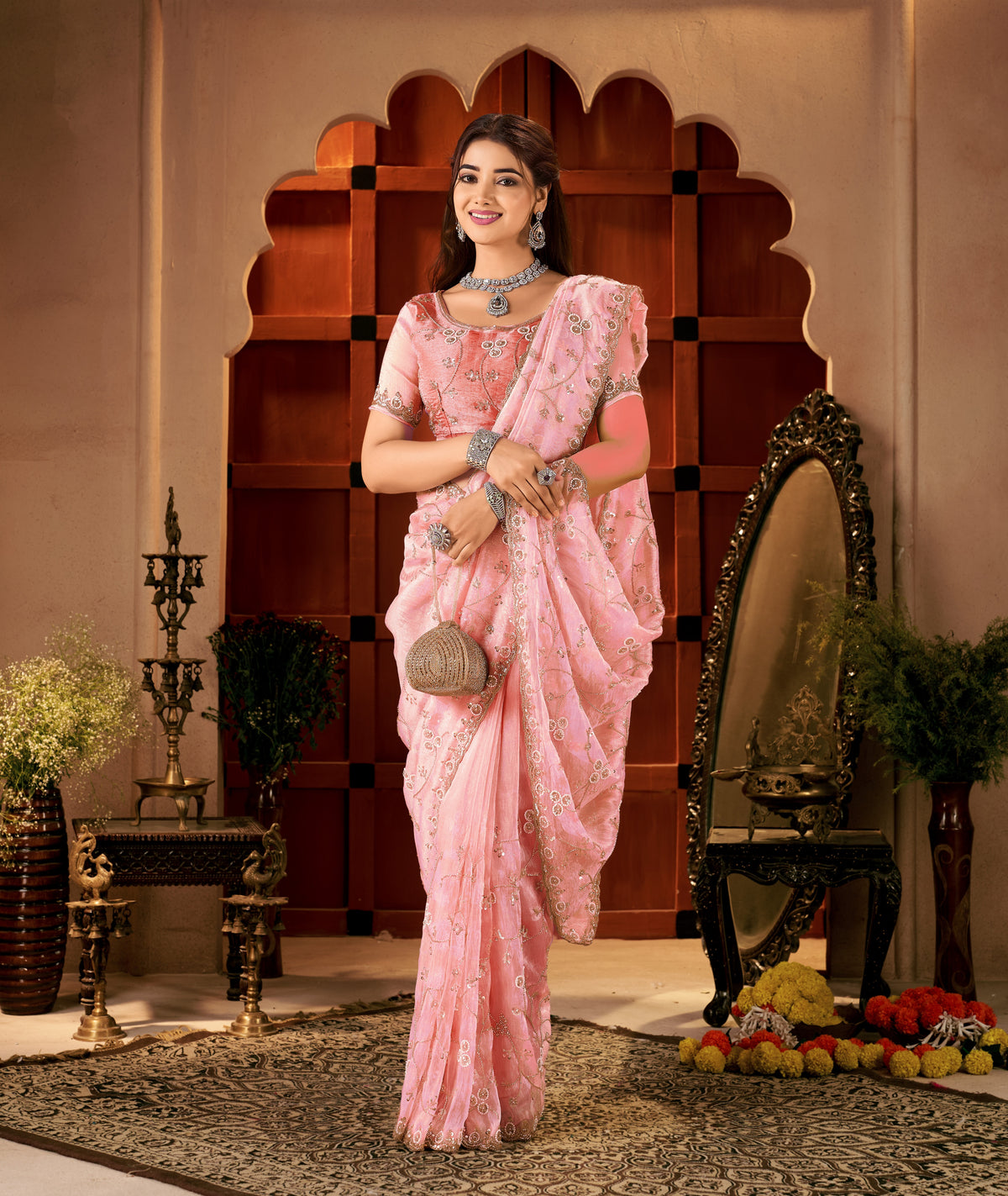 model wearing the chhoga rose pink tissue silk saree with elegant hand work, full front view.