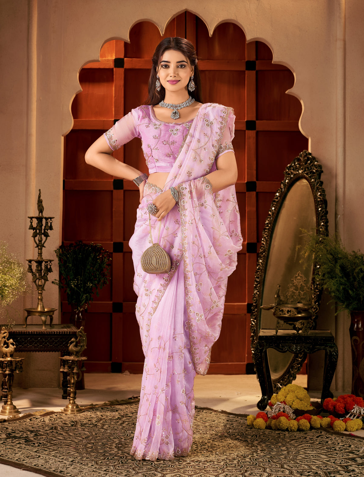 Detailed view of the luxurious tissue silk fabric and floral hand work.