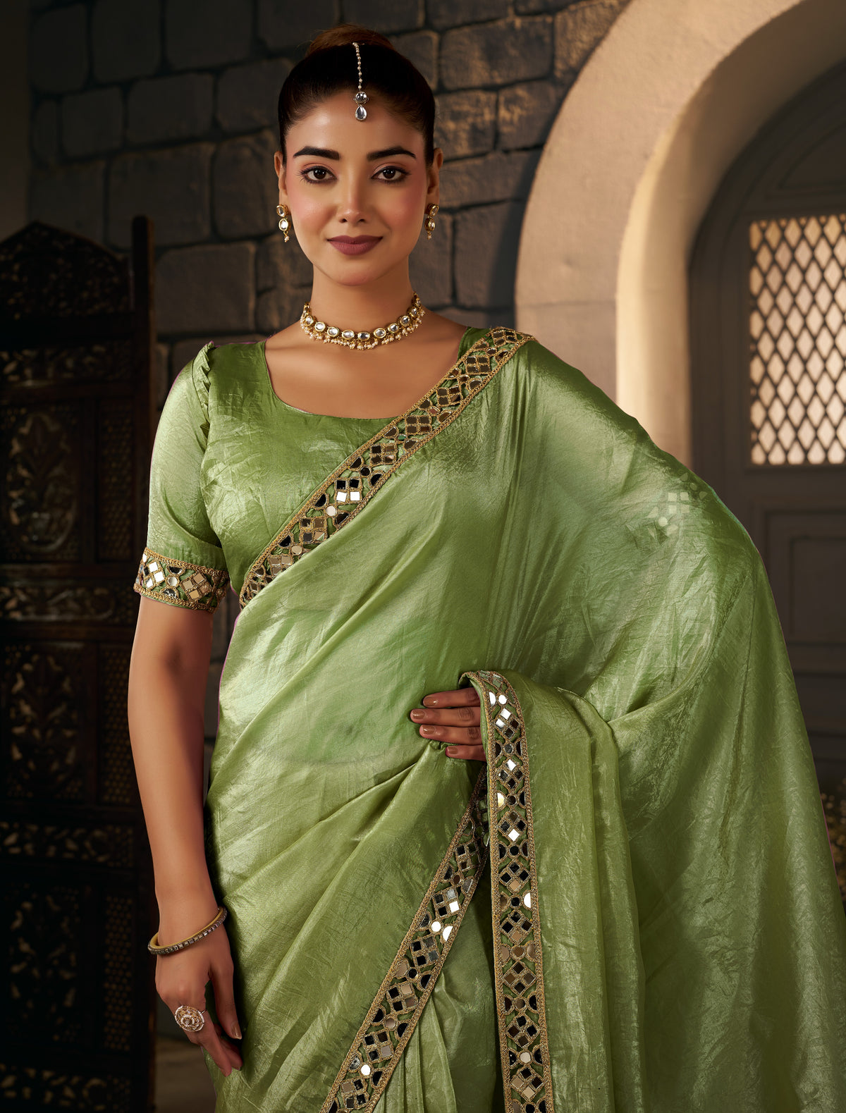 pistachio green crush tissue silk saree with artisan mirror border