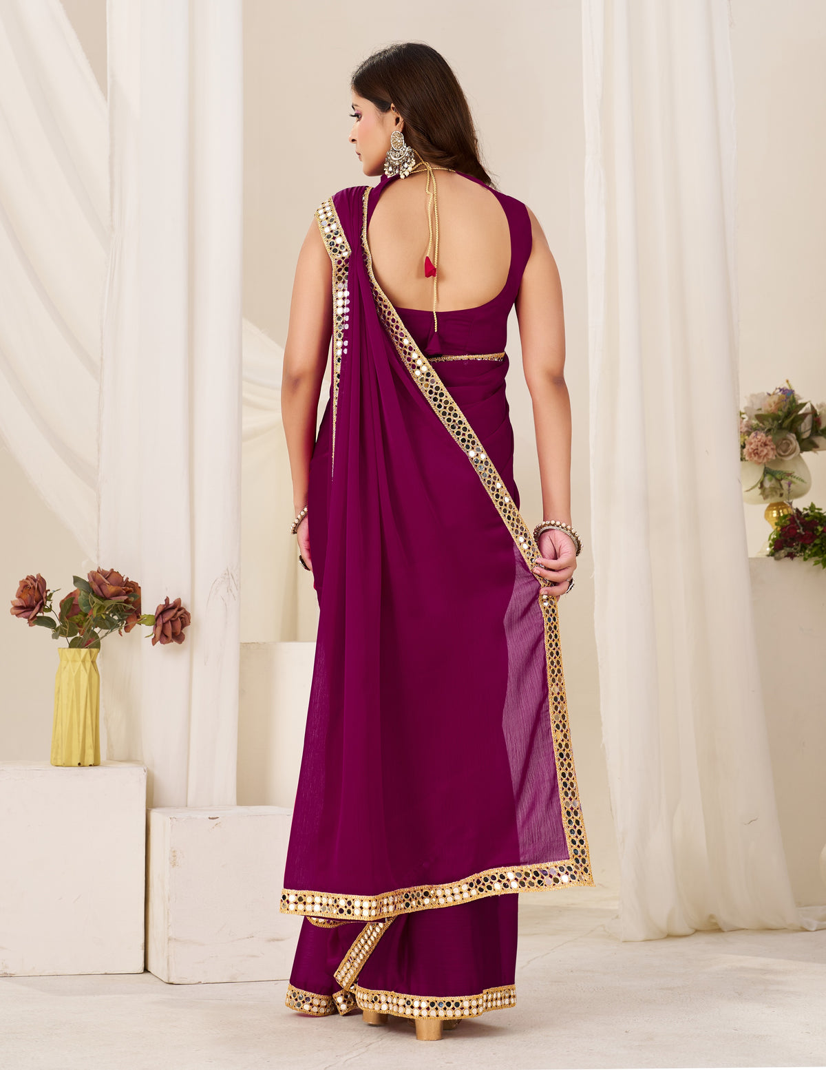 back view of chiffon silk deep magenta saree with gold mirror border