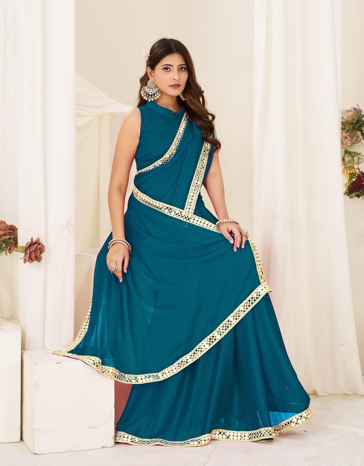 chiffon silk peacock blue saree with gold mirror border for festive celebrations
