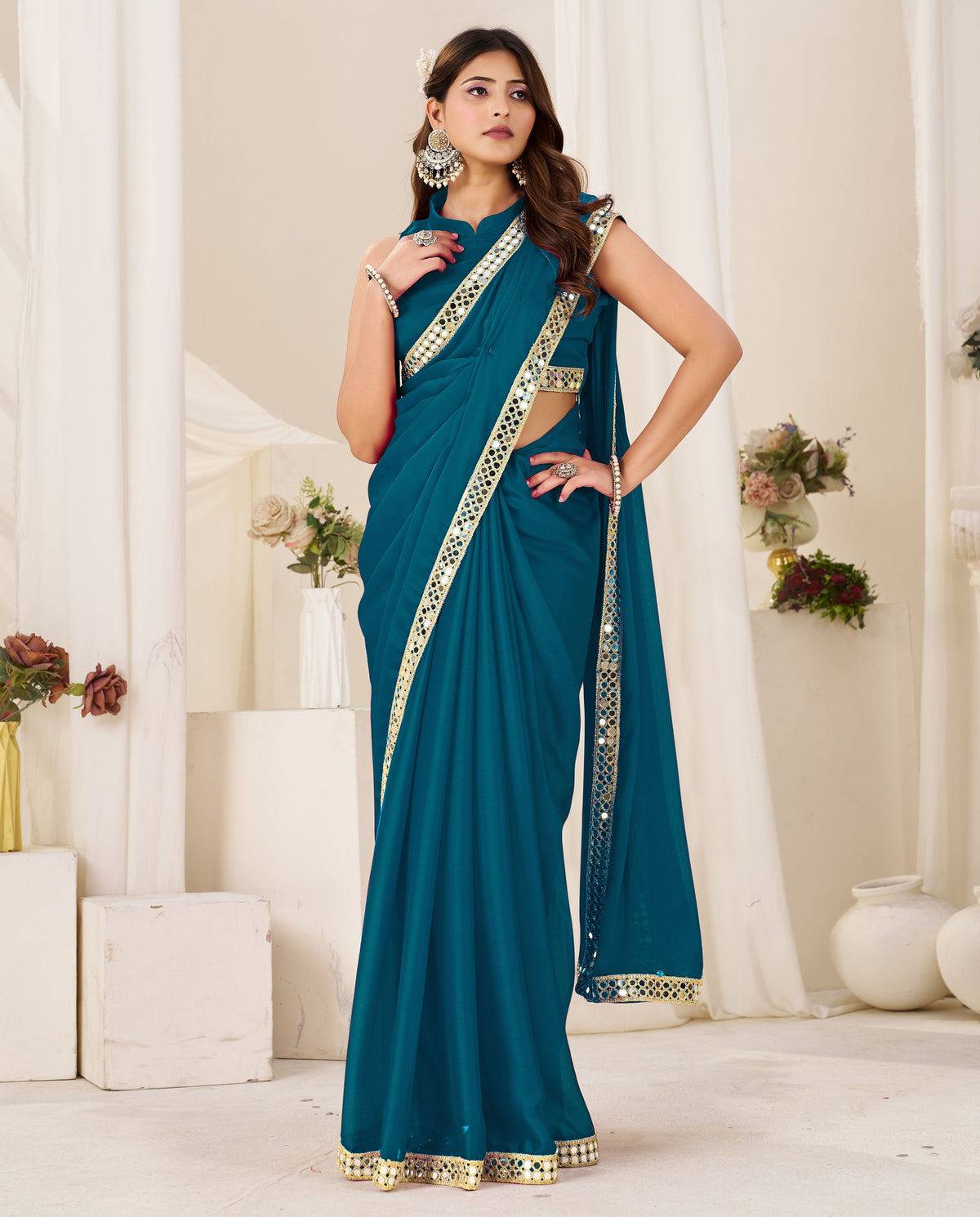full view of chiffon silk peacock blue saree with gold mirror border