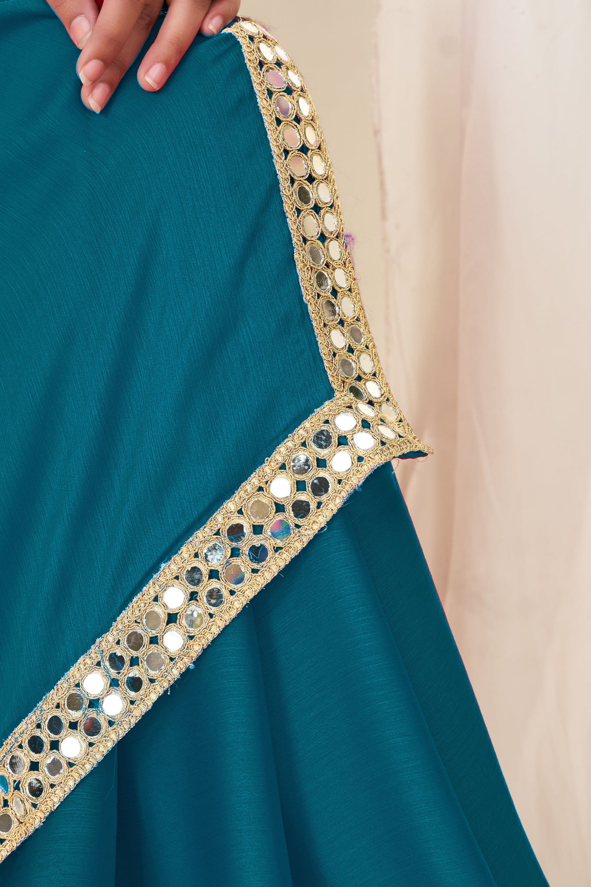 Close-up of gold mirror work on Chiffon Silk Peacock Blue Saree