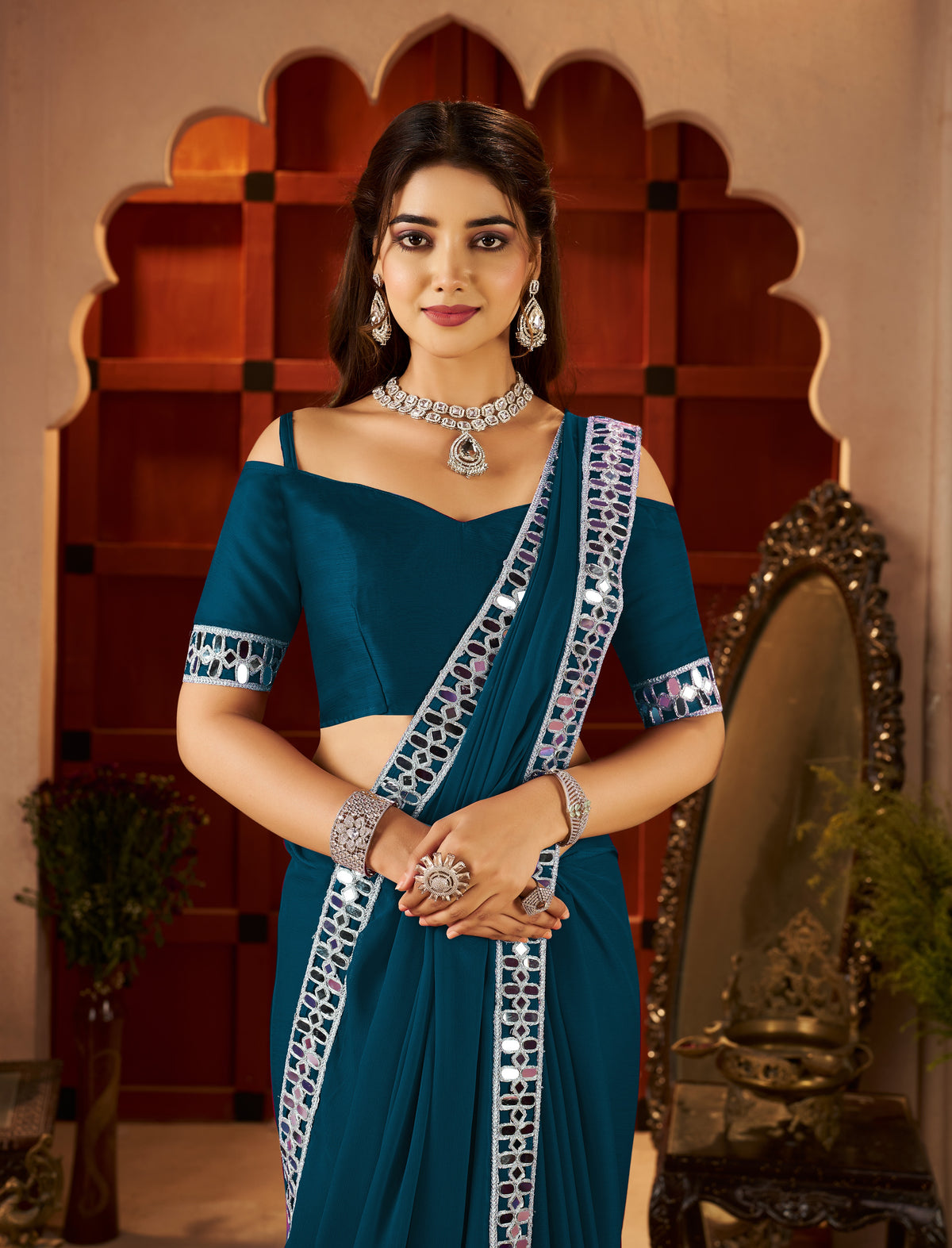 Half view of Chiffon Silk Peacock Blue Saree with Mirror Embellished Border