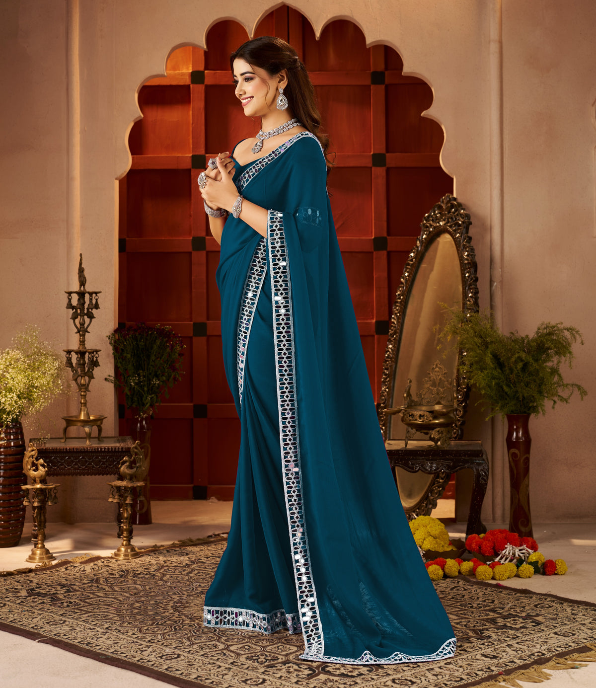side view of chiffon silk peacock blue saree with mirror embellished border