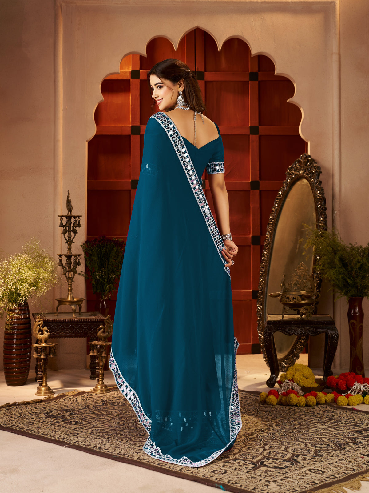 pallu detail of chiffon silk peacock blue saree with silver mirror embellished border