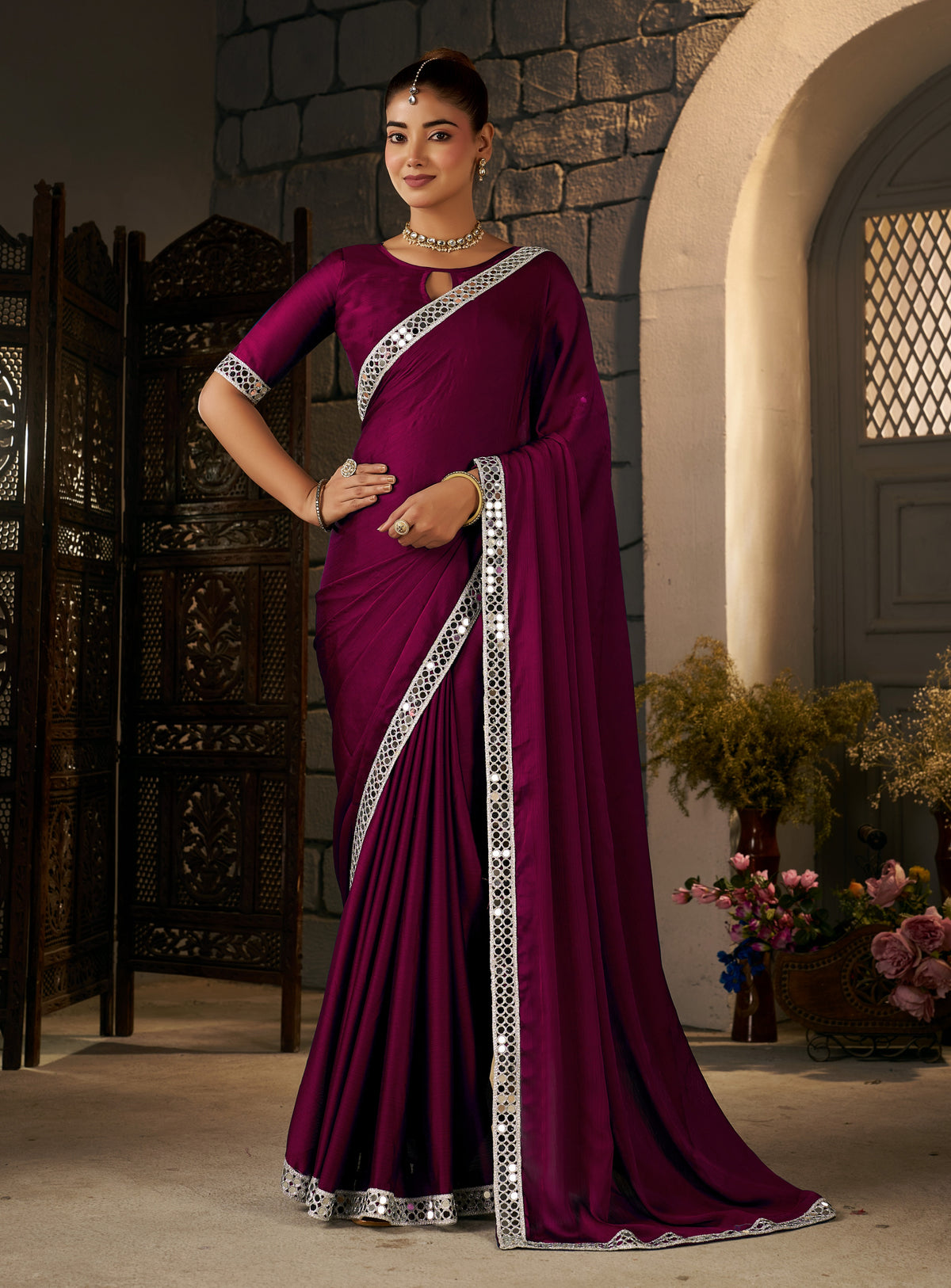 deep magenta ethnic saree with silver mirror work styled for wedding occasions