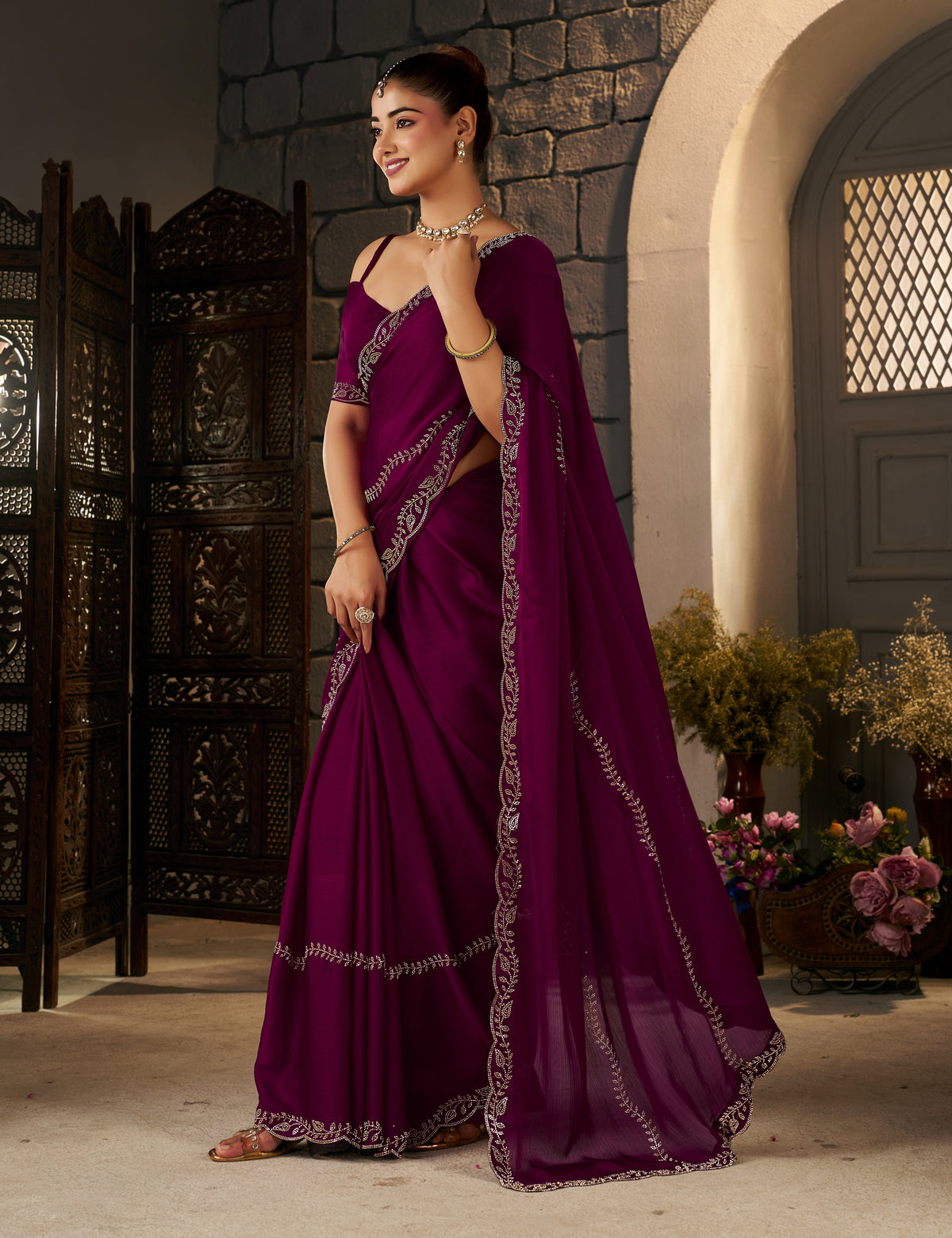 side profile of the deep magenta silver stonework designer saree highlighting its elegant drape.