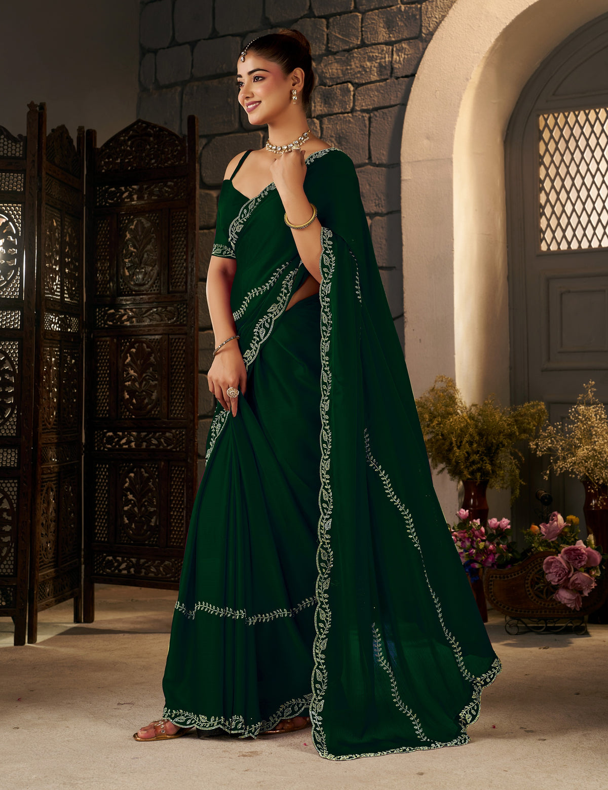 complete look of the emerald green gold stonework designer saree with matching blouse piece and elegant gold stonework.