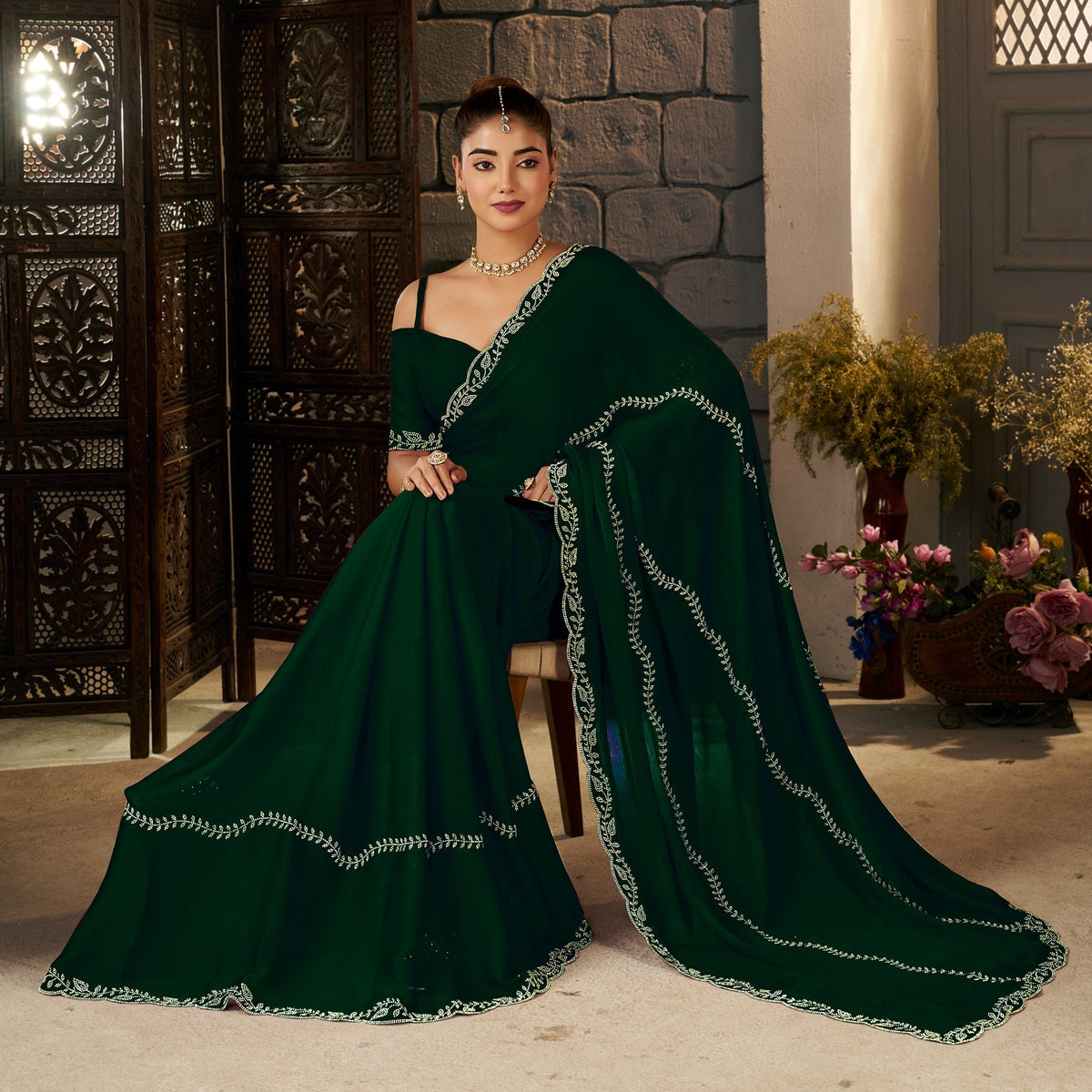 front view of emerald green gold stonework designer saree with elegant gold embellishments by chhoga.
