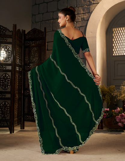 Detailed view of the pallu with intricate gold stonework on the Emerald Green Designer Saree.