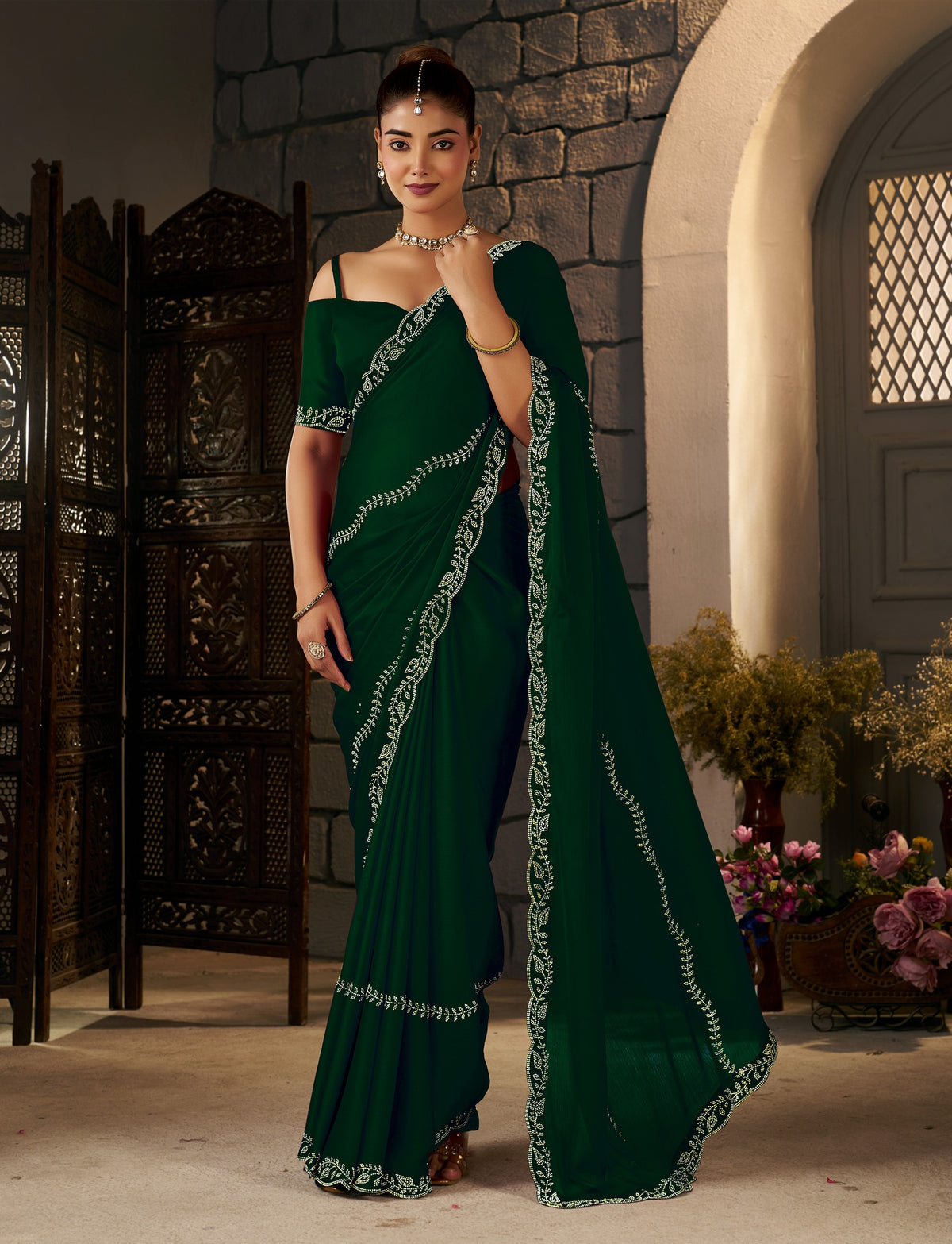 Pleats of the Emerald Green Gold Stonework Designer Saree showcasing its elegant drape.