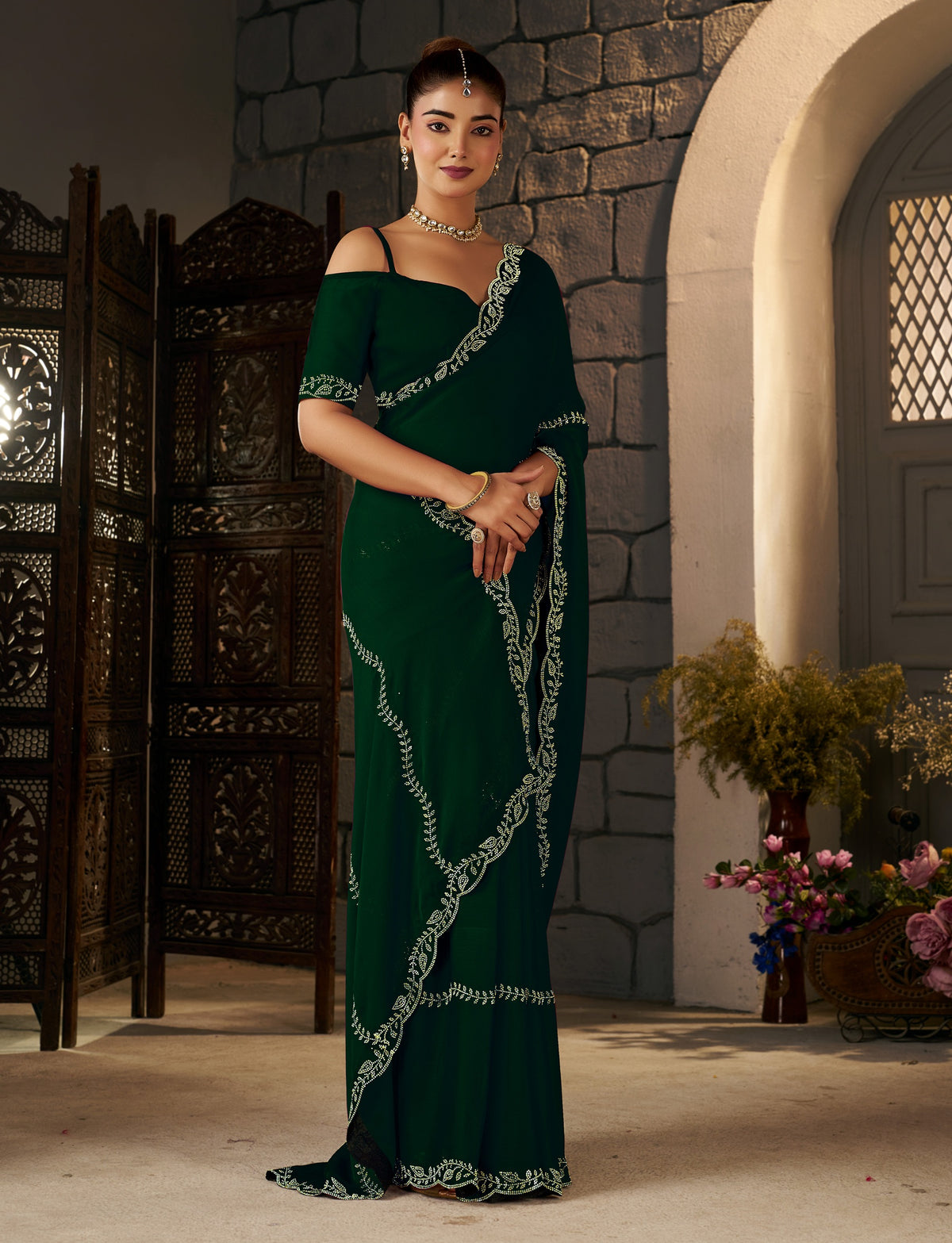 elegant wedding look featuring the emerald green gold stonework designer saree by chhoga.