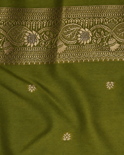An olive green fabric close-up with a wide beige floral and geometric woven border across the top and small scattered beige floral motifs below.