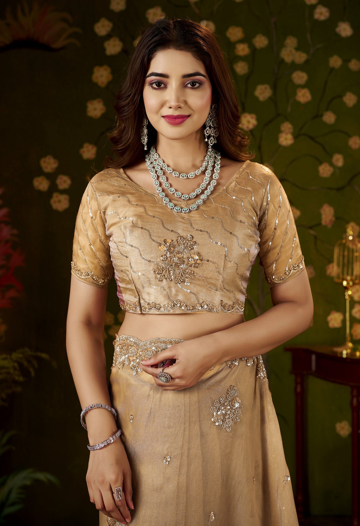 model wearing the handcrafted champagne gold regal bloom soft tissue saree for festive occasions.