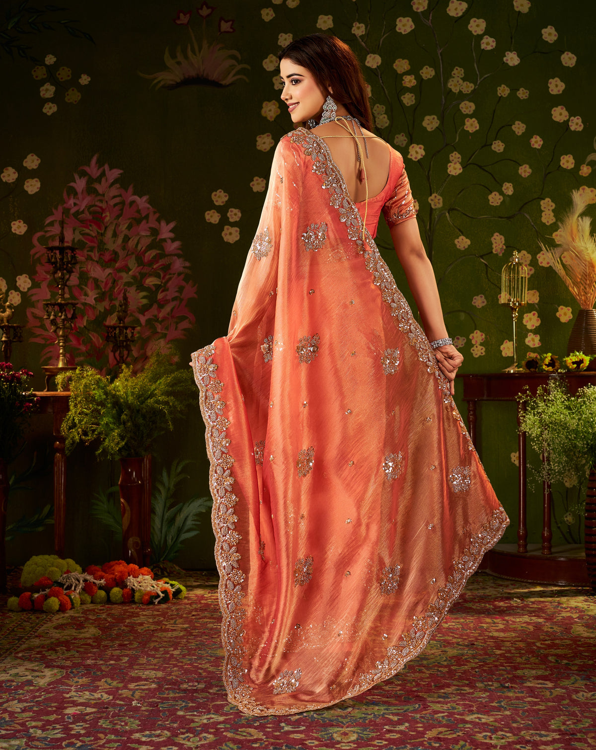 back view of handcrafted peach coral regal bloom soft tissue saree.