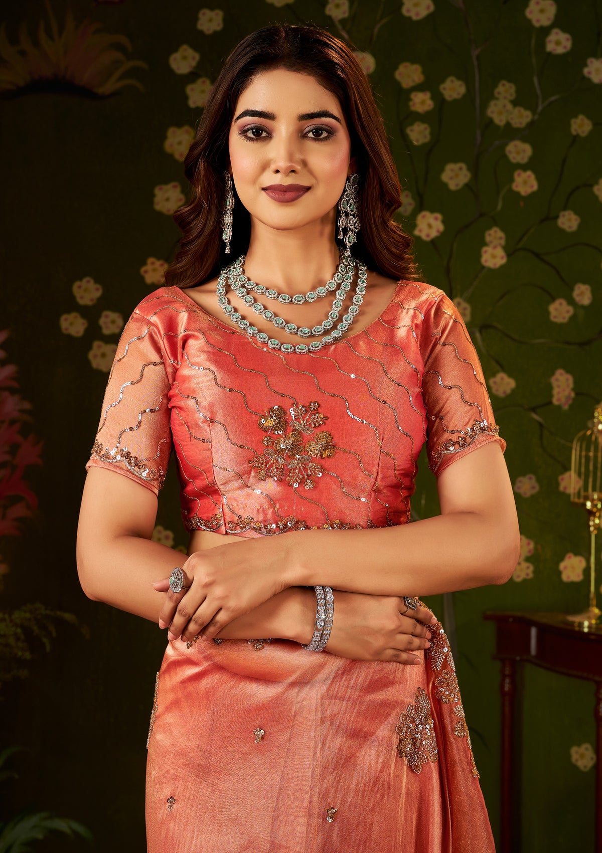 intricate handcrafted blouse detail of peach coral regal bloom soft tissue saree.