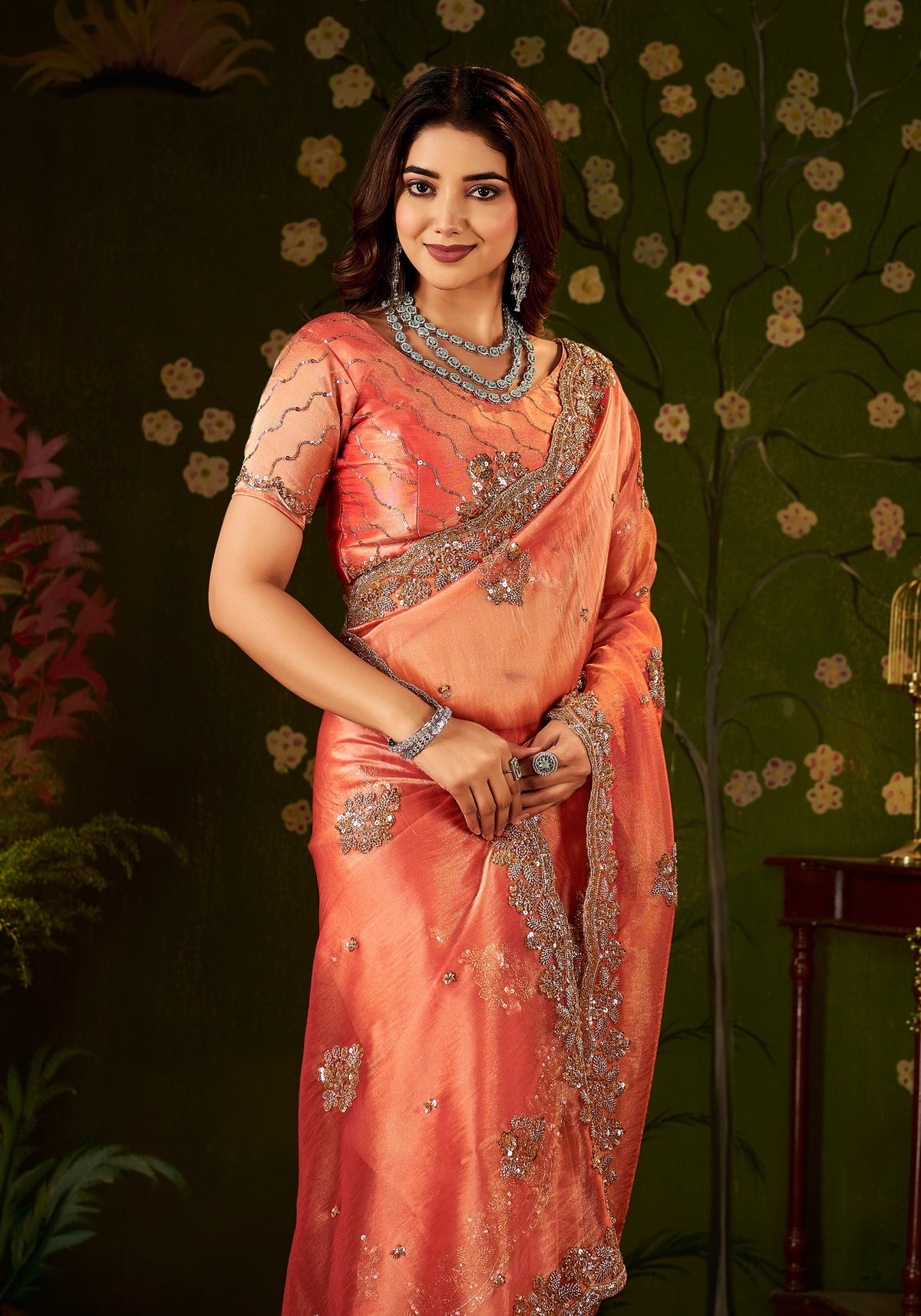 elegant half view of handcrafted peach coral regal bloom soft tissue saree.