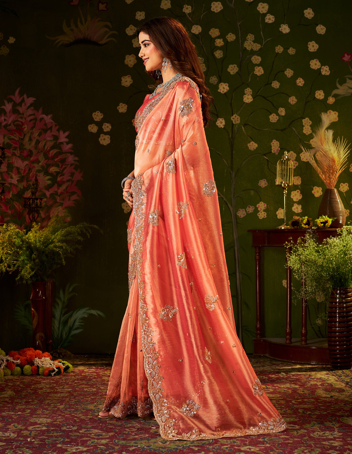 handcrafted peach coral regal bloom soft tissue saree styled for festive celebrations.
