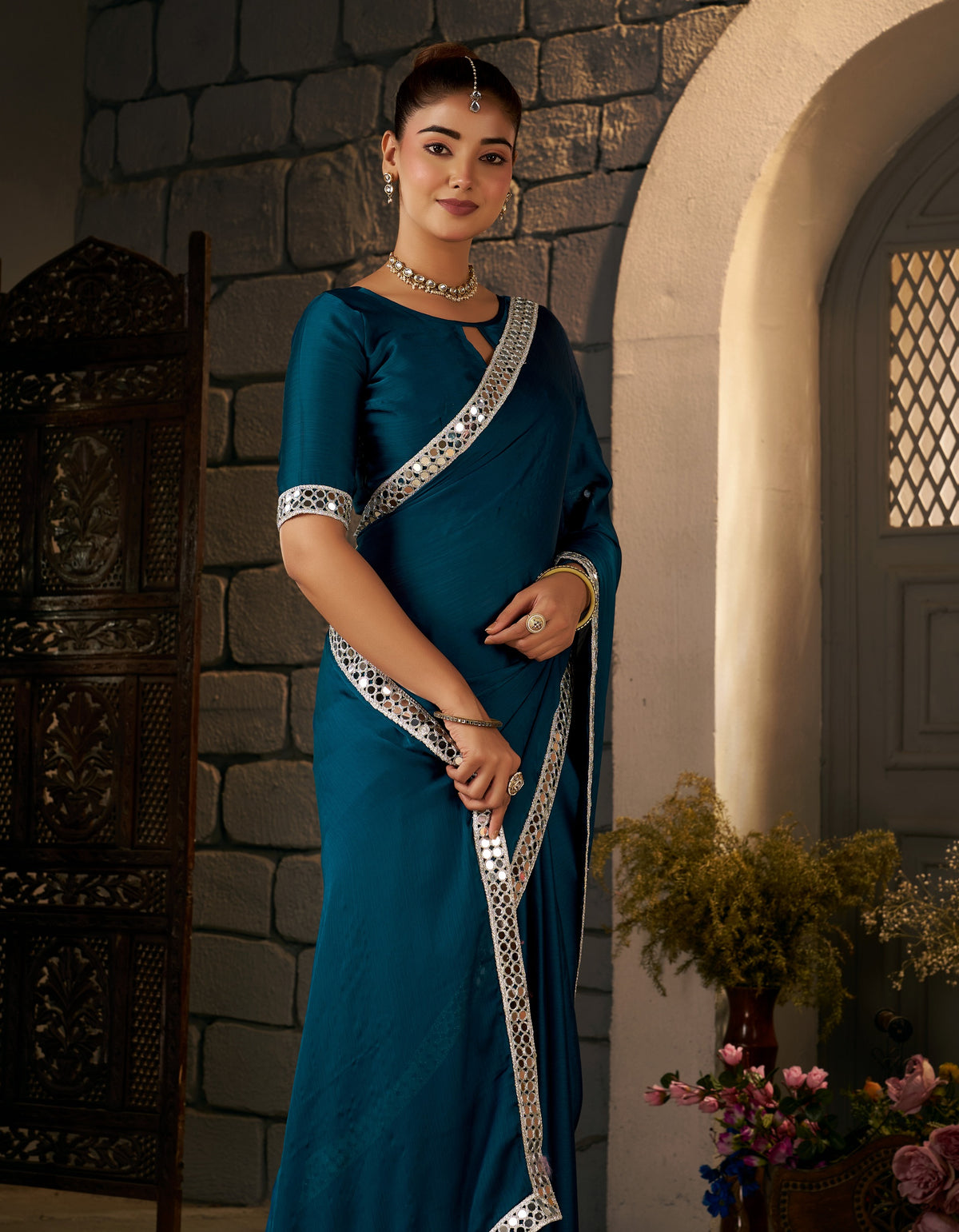 peacock blue ethnic saree with silver mirror work styled for wedding occasions
