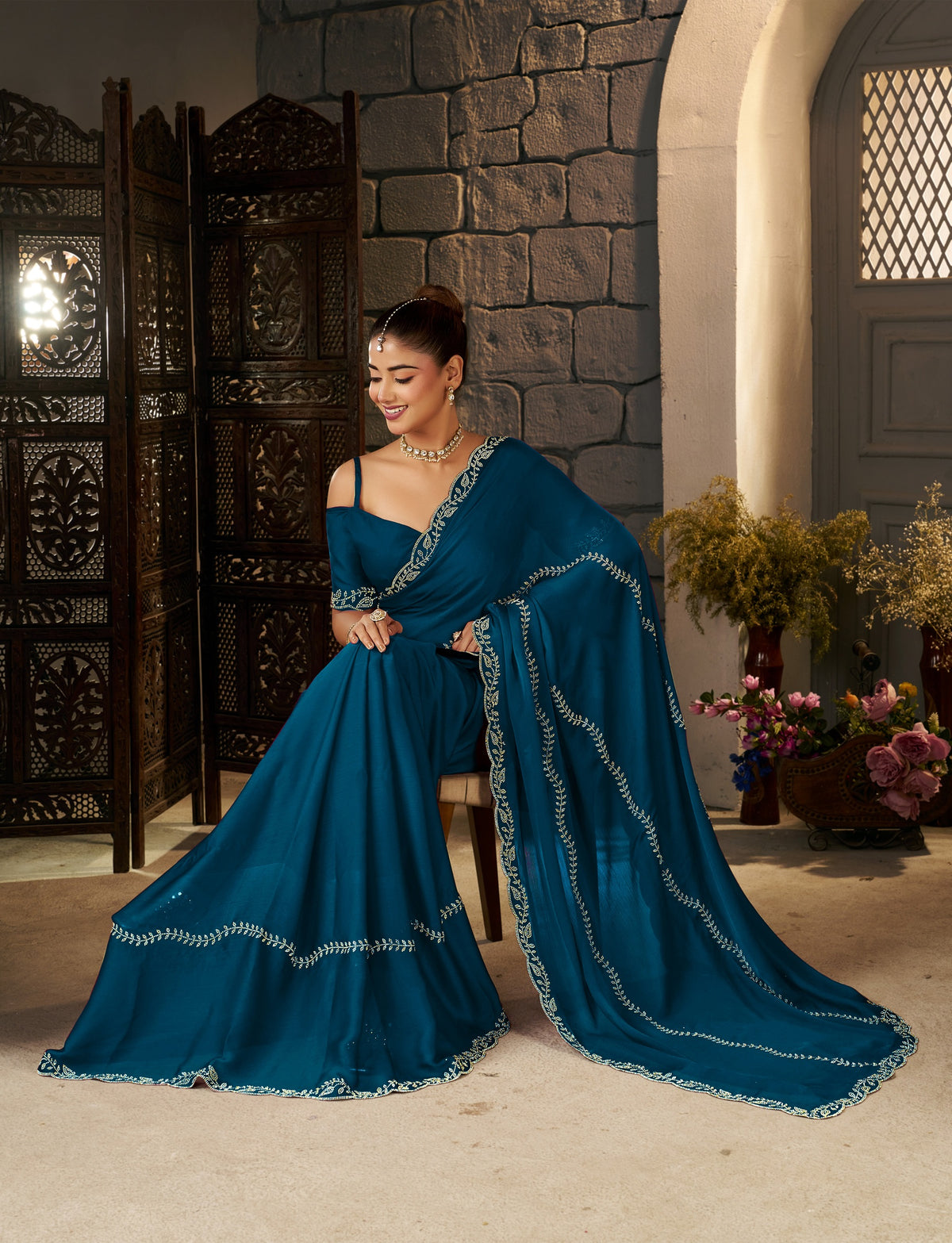 Peacock Blue Gold Stonework Designer Saree styled for festive celebrations.
