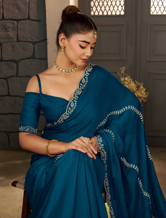 Half view of the Peacock Blue Gold Stonework Designer Saree highlighting its elegant drape.