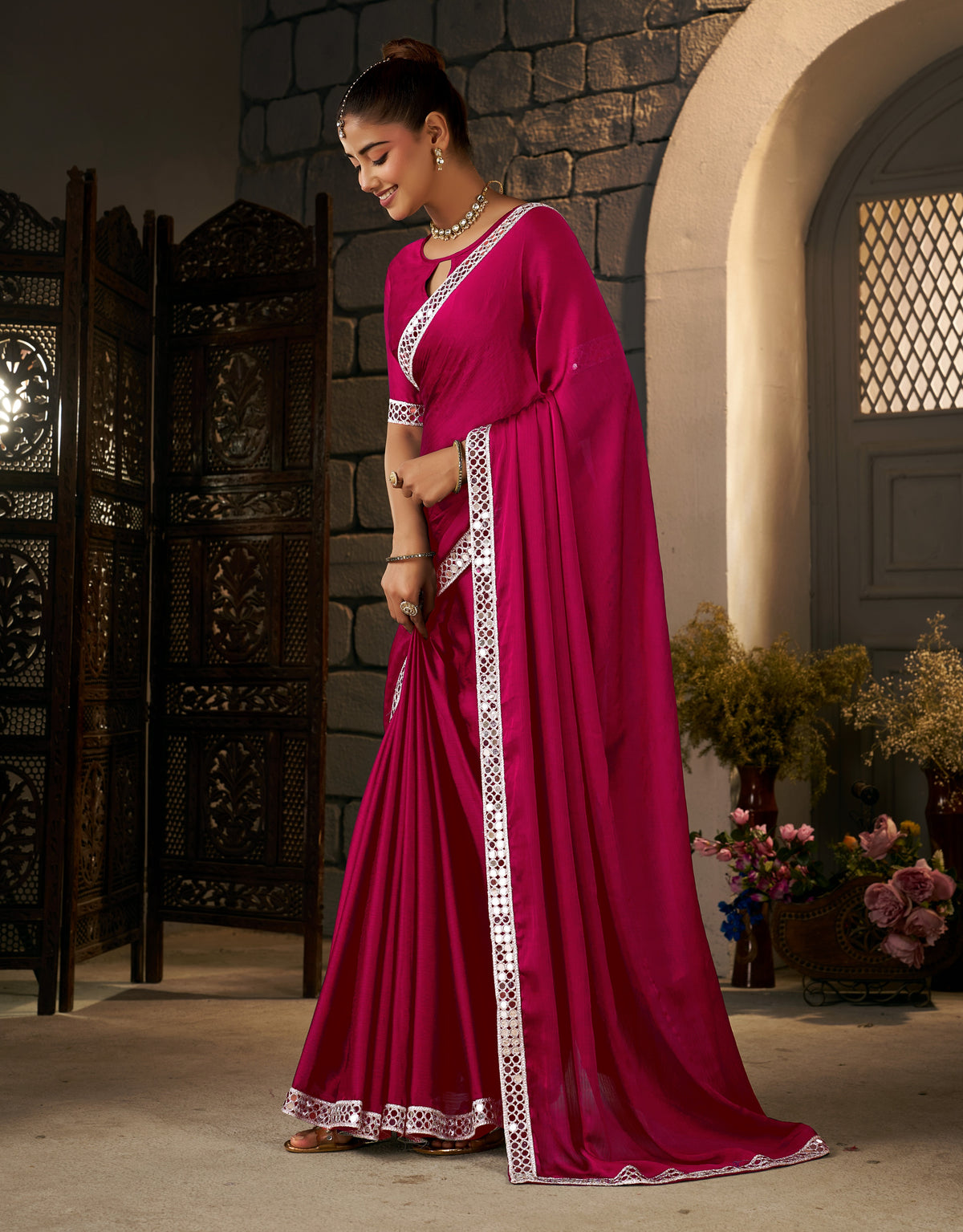 pink ethnic saree with silver mirror work styled for wedding occasions