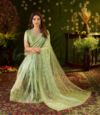 Editorial shot displaying the lightweight movement and drape of pista green tissue saree.