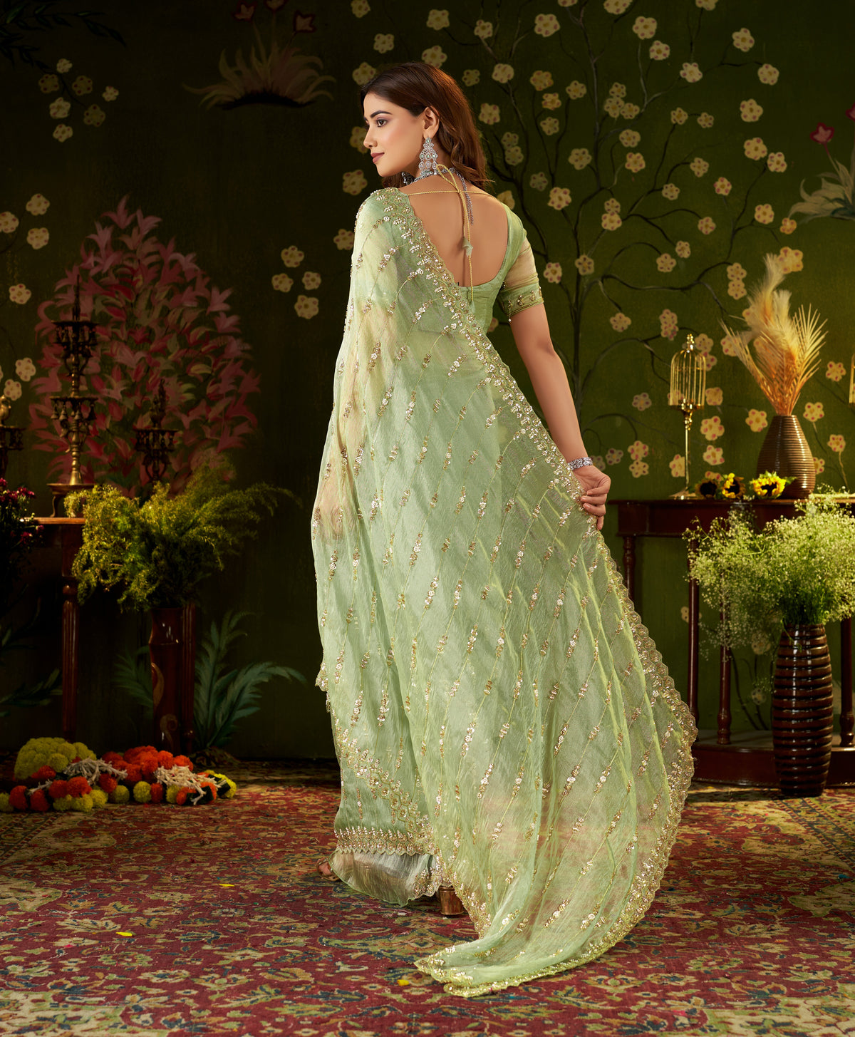 Back shot showing hand-embroidered tissue silk blouse pattern and pallu drape.