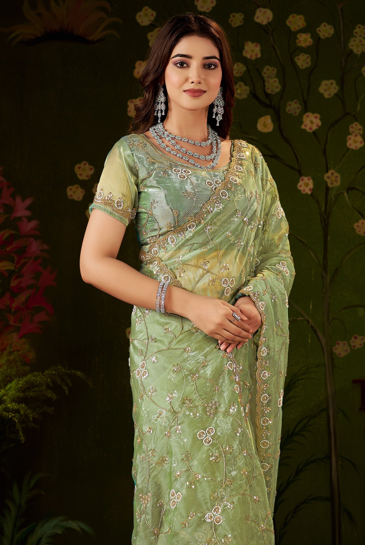 elegant half view of chhoga pistachio green tissue silk saree with embellished floral design