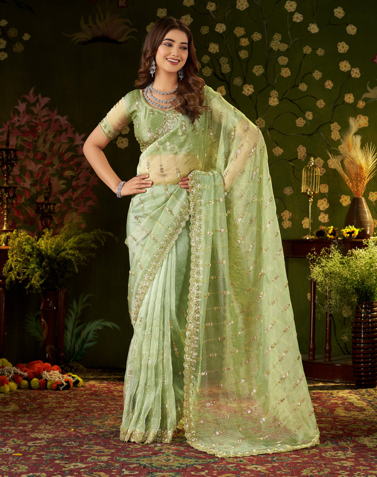 full-length studio shot of model wearing chhoga pistachio green floral tissue silk saree.