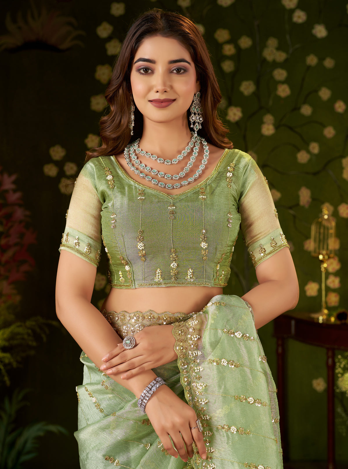 front view of matching pistachio green tissue silk blouse with embroidered neckline.