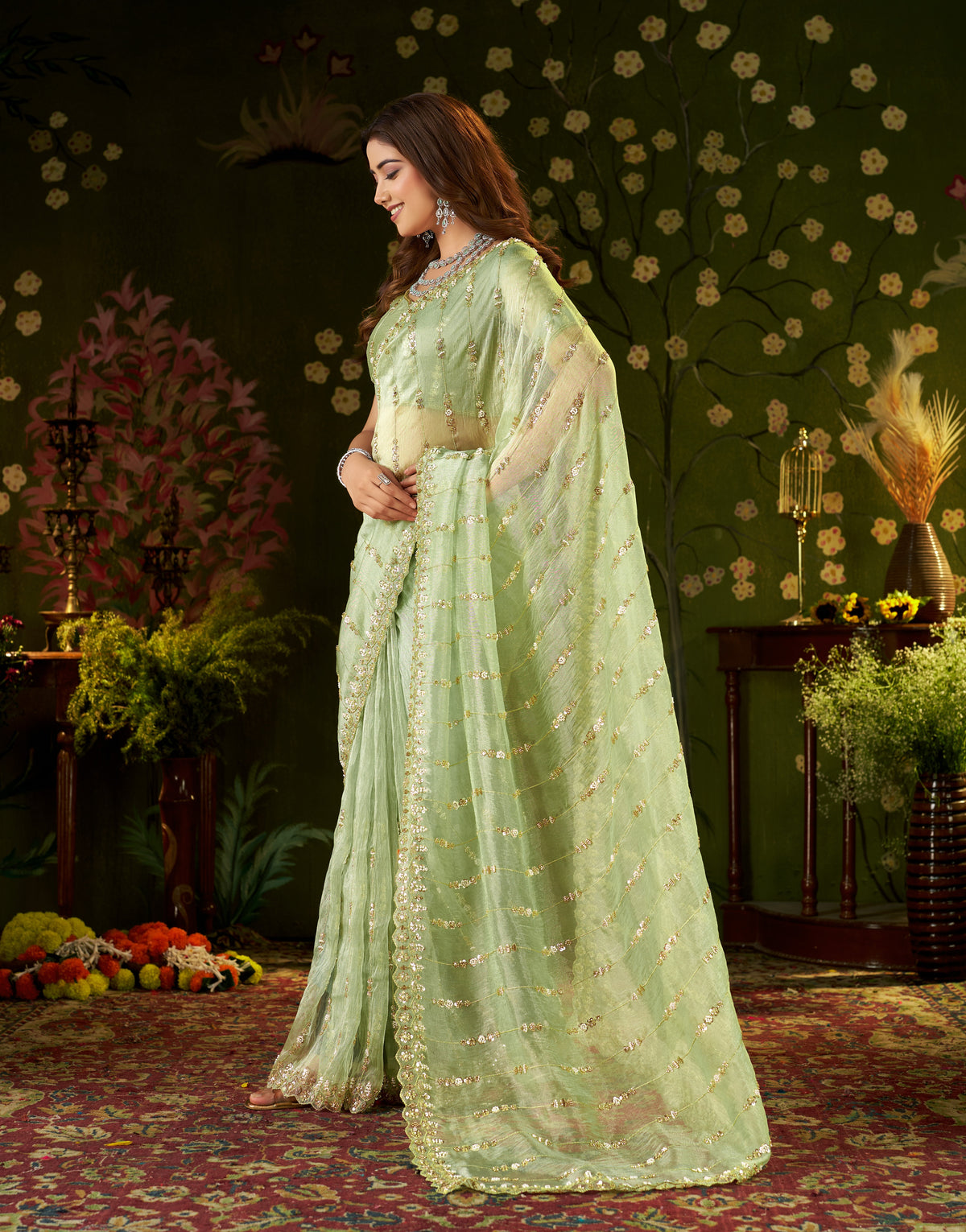 Studio flat lay shot of pistachio green tissue silk saree with unstitched blouse piece.